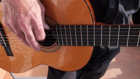 Senior man playing spanish guitar at home balcony - Powered by Shutterstock - Get 15% off with code: PIKWIZARD15