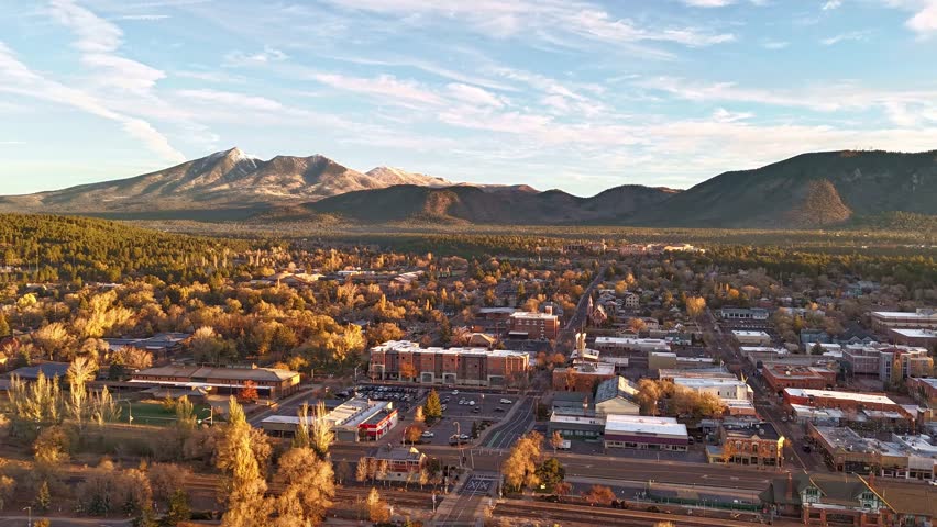 Flagstaff, Arizona, USA, time lapse over downtown, the San Francisco mountains, morning sun, late fall. Partly cloudy
