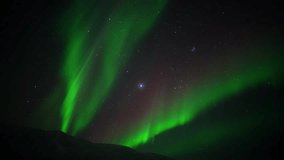 Aurora Borealis Moving Beneath a Starry Night Sky Over Mountain In Iceland - Powered by Shutterstock - Get 15% off with code: PIKWIZARD15