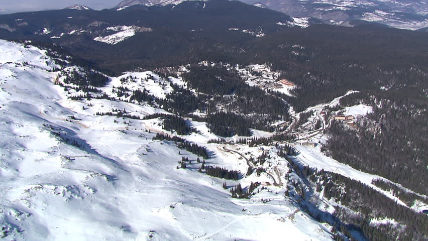 Snowy mountain Jahorina with tourist center. Aerial helicopter shot.