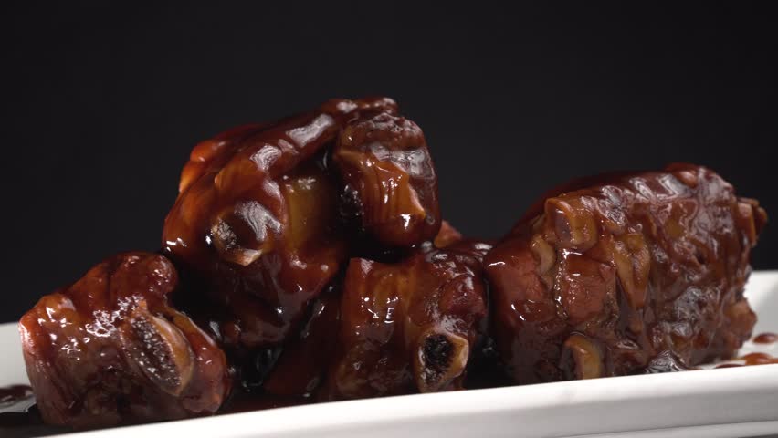 Pork ribs in honey soy sauce on a wooden background. Food concept. Chinese food.