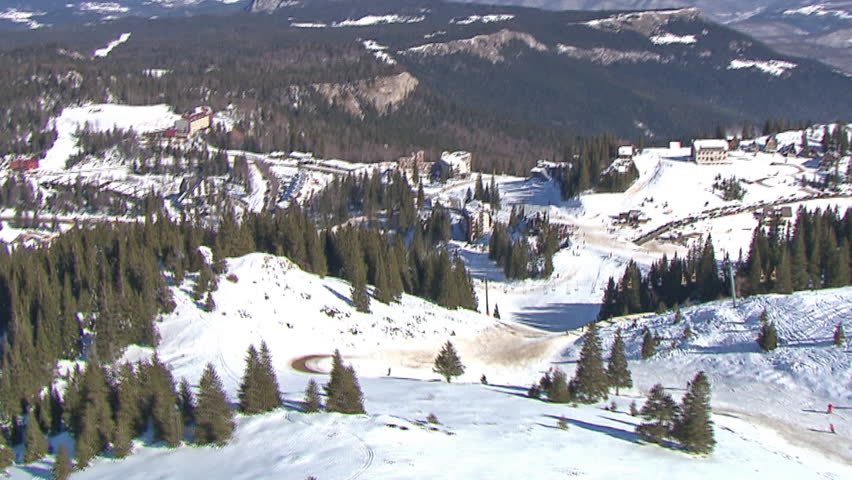 Aerial helicopter shot of people skiing, mountain Jahorina