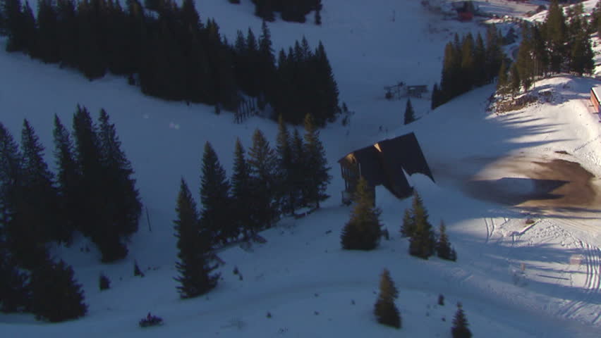 Aerial helicopter shot of a snowmobile on the mountain of Jahorina
