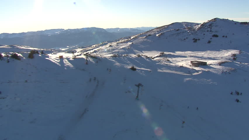 Snow peaks of the mountain Jahorina with cable cars. Aerial helicopter shot.