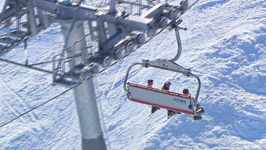 Aerial shot of a cable car with three persons, mountain Jahorina