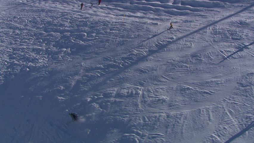 Aerial helicopter shot of people skiing, mountain Jahorina