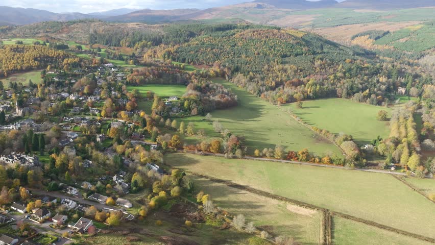 helicopter vibrant autumn colors scottish countryside village surrounded by fields mountains scenery shot visuals landscape vibrancy nature experience aesthetics exploration