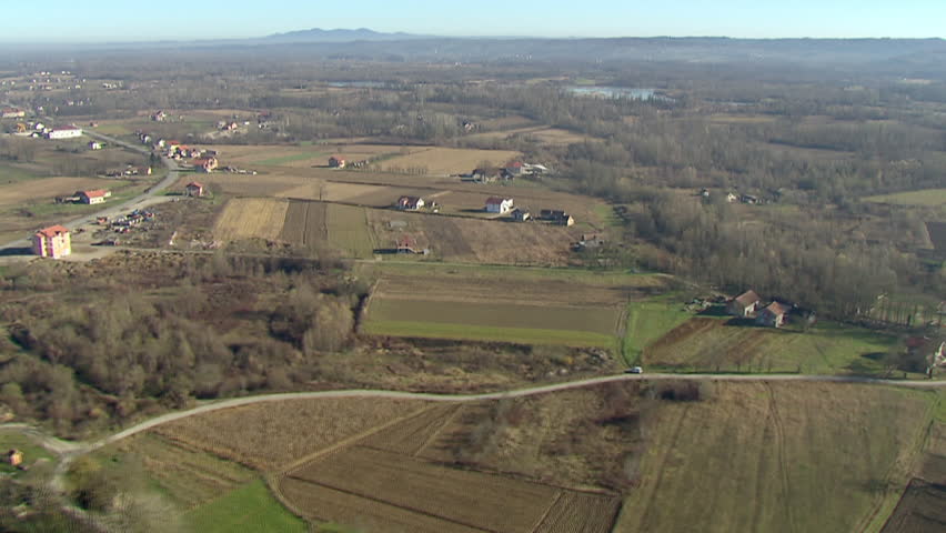 Aerial helicopter shot of rural area with a river