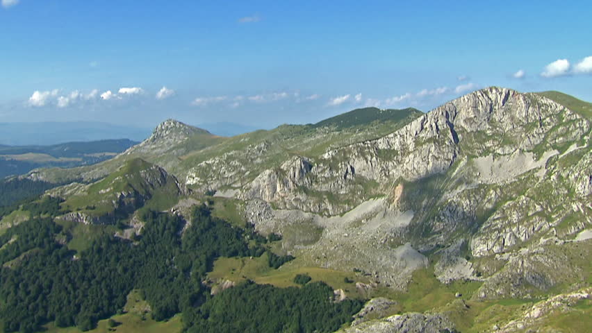 Aerial shot of rocky terrain of Dinaric Alps with a small lake, Bosnia