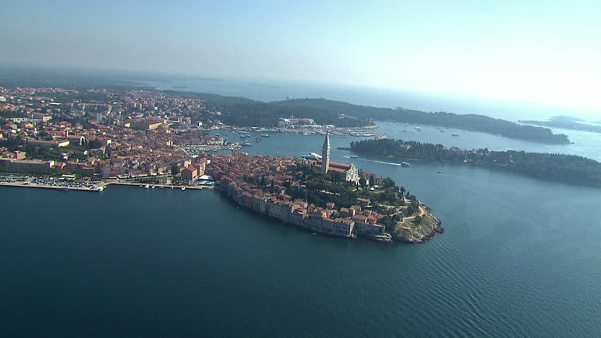 Aerial shot of the City of Rovinj with a marina in the background and a small
