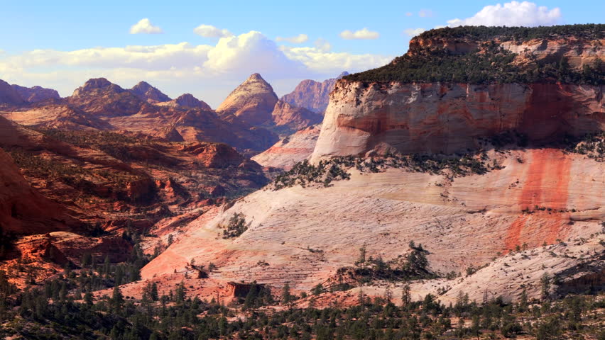 An absolutely breathtaking aerial view captures the vibrant rock formations along with the beautiful and diverse landscape of Zion National Park during the enchanting moments of sunset