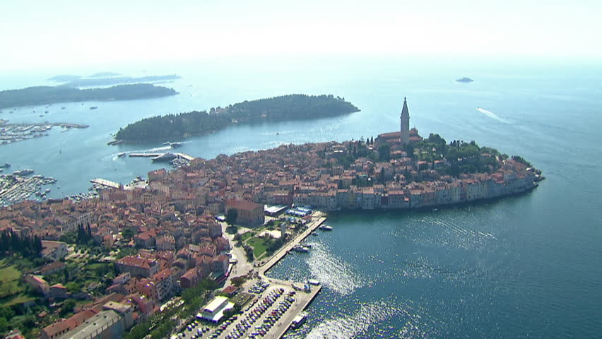 Aerial shot of the City of Rovinj with a marina in the background and a small