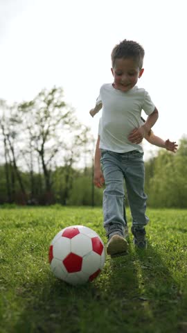 Children playing team game in park. Kids enjoying soccer game together. children running in park. Siblings as team playing game. Fun outdoor activity for children. Joyful moments with children playing