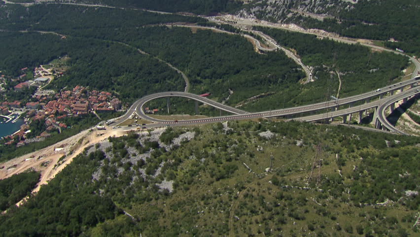 Helicopter view of a freeway junction surrounded by nature, Croatia