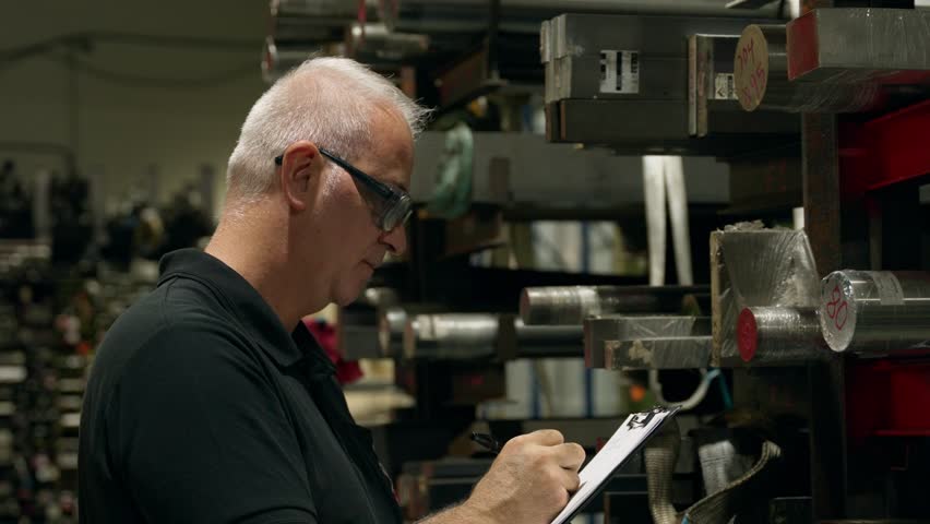 Supervisor taking notes of metal inventory - Powered by Shutterstock - Get 15% off with code: PIKWIZARD15