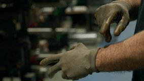 Factory worker putting on protective gloves - Powered by Shutterstock - Get 15% off with code: PIKWIZARD15
