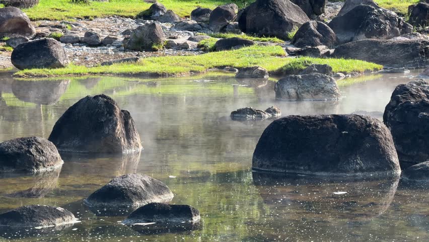 Natural Open Air Hot Springs, Steam is Coming from hot rocks and water surface	