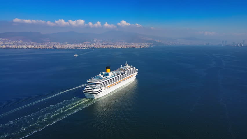 Aerial view of a cruise ship sailing the sea on a sunny summer day arrive destination touristic city.