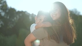 Baby riding piggyback on mother in nature. Happy family playing together outdoors. Joyful mother and child in park. Family piggyback rides. Fun time together in nature. Smiling baby and mother. - Powered by Shutterstock - Get 15% off with code: PIKWIZARD15