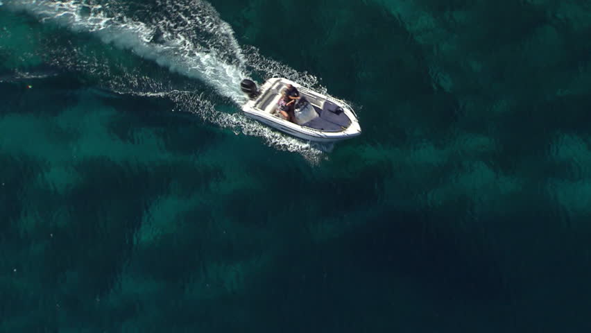 A speedboat speeds across Adriatic sea near Kornati islands. Aerial helicopter