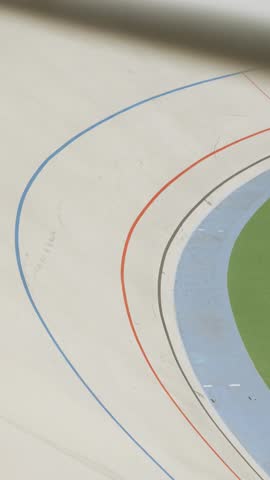 Track cycling team riding at velodrome. Track bicycle race on open cycling track. Vertical video