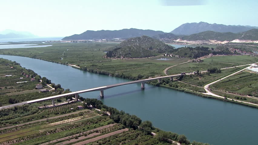 Aerial shot of a bridge over the river Neretva discharging into the Adriatic sea