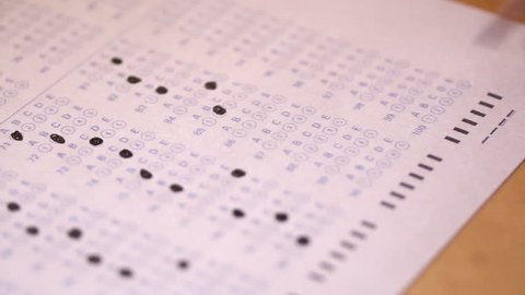 A close-up look at filling in the little circles of a test paper.