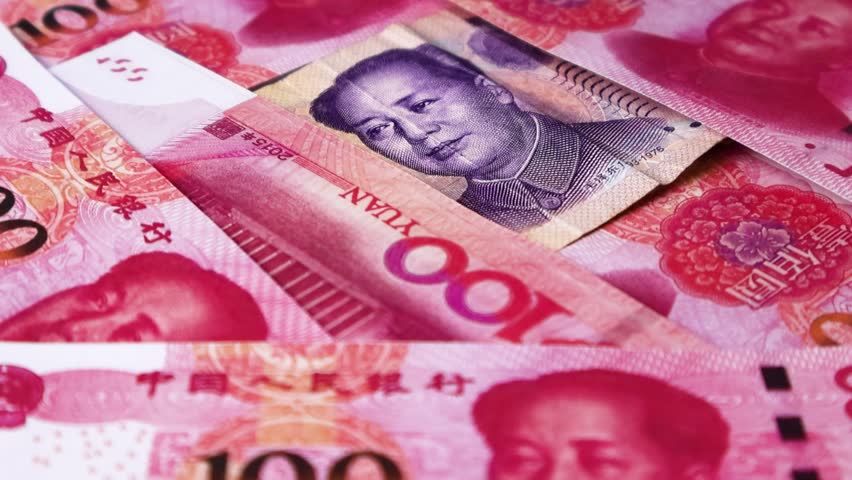 Camera panning 360 degrees around spread 100 Chinese Yuan  notes. Camera moving spinning rotating revolving around Scattered Yuan notes on surface. Looping HD video