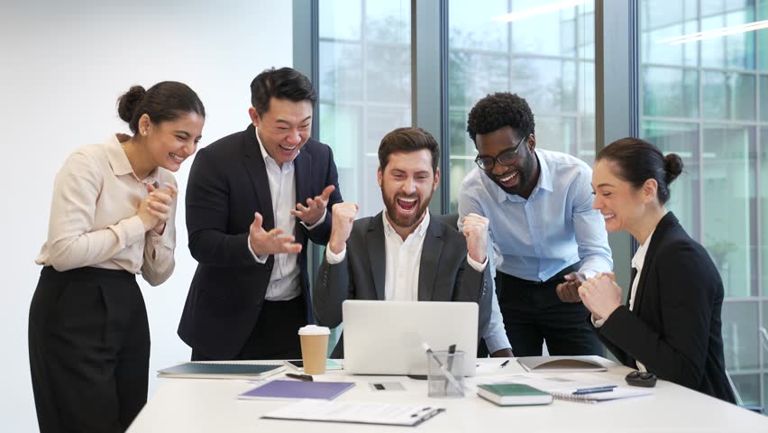 Team business people celebrate success and achievement look at laptop computer Group professional teamwork at modern office partnership received good news happy employees celebration corporate victory