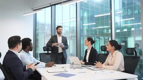 Group of business people meeting in office. Diverse corporate team of professionals in suits discussing strategy or startup. Brainstorming briefing co-workers colleagues communicate at conference  - Powered by Shutterstock - Get 15% off with code: PIKWIZARD15