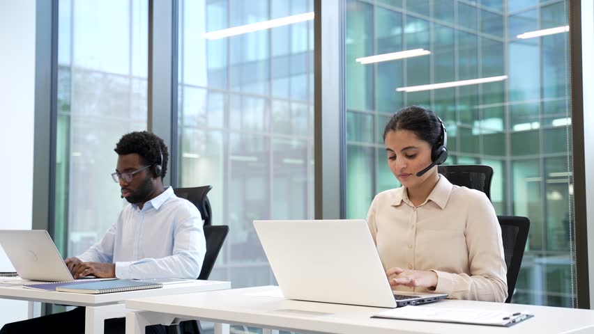 Team of Customer Service Representatives manager Working at Computers with Headsets Corporate operators technical support specialist consulting client call center Group friendly smiling Employee agent