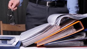 close-up man opened a folder with documents and reads a document - Powered by Shutterstock - Get 15% off with code: PIKWIZARD15