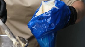 A pastry chef makes eclairs in a bakery. eclairs are baked in the oven. eclair production process. pastry bag with dough - Powered by Shutterstock - Get 15% off with code: PIKWIZARD15