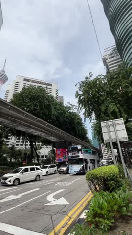 Malaysia, Kuala Lumpur, November 25, 2024; traffic atmosphere on the road in the city center of Kuala Lumpur, Malaysia. vertical footage