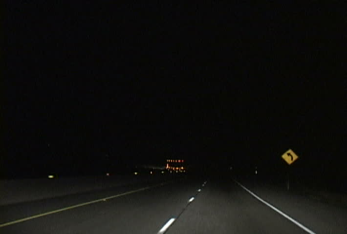 Driving at night on highway in California.