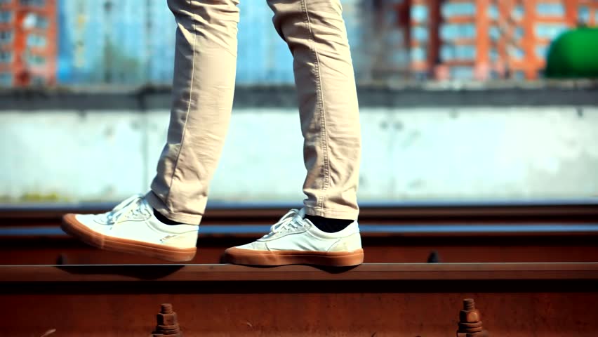 Man Walks To Home On Railroad Tracks After Canceled Public Transport .Tourist Legs Walking On Railway Middle Of Rail.Lonely Businessman Feet In Pants Walking On Rail Road When Train Or Tram Cancelled.
