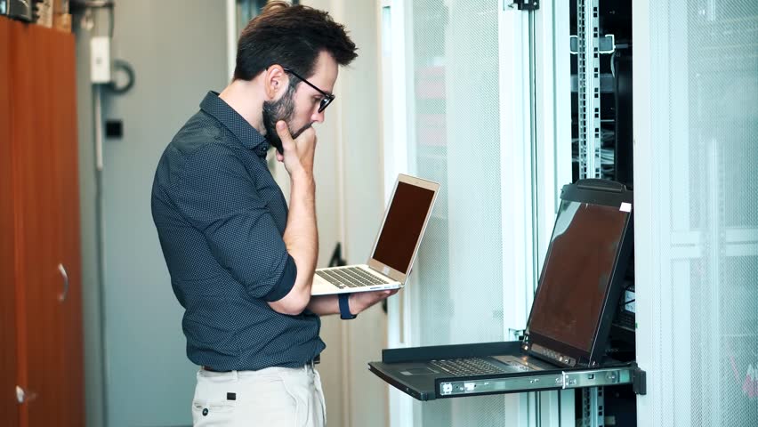 Technician Testing Network Connection. Hardware Updates On Server Room. Engineer Connect Network Cable To Switch. Data Center Network Cable Network Technology. System Administrator Configures Ethernet