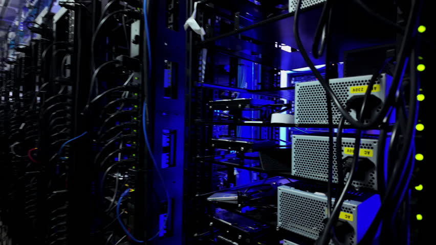 Close up of multiple rack-mounted servers in data centre