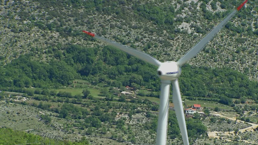 Aerial helicopter shot of wind farm fans
