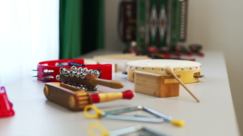 Musical instruments lie on table in dressing room of rural Philharmonic. Preparing of local music band for concert program. Folk music