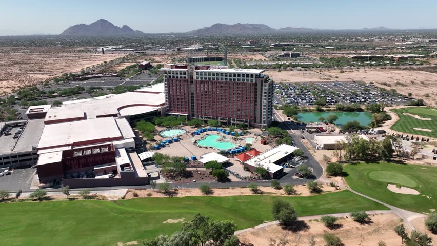 Aerial view of Talking Stick resort and casino with golf course, swimming pool, and distant mountains, Scottsdale, United States.
