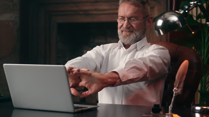 Caucasian old man businessman business male elderly stretching hands fingers start work laptop entrepreneur finance technology computer typing office internet online mature worker employee desktop pc