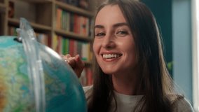 Caucasian woman spinning globe dream choosing country travel traveler wish smile female student girl teacher geography global map world choose study learner pointing finger library school university - Powered by Shutterstock - Get 15% off with code: PIKWIZARD15