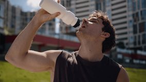 Caucasian man athlete sportsman sport male drinking water bottle thirst breathing hard workout runner guy tired exhausted city outside refresh pause break sportive cardio exercises active training run - Powered by Shutterstock - Get 15% off with code: PIKWIZARD15