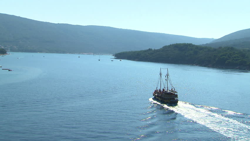 A wooden tourist boat across the Adriatic sea. Aerial helicopter shot