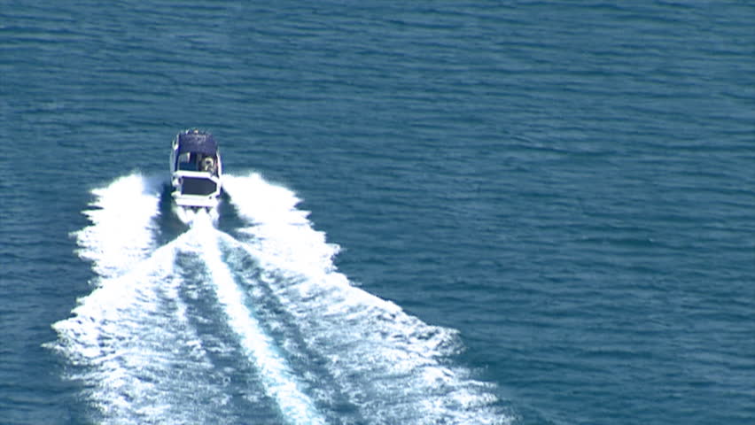 Aerial helicopter shot of a speedboat that speeds across Adriatic sea