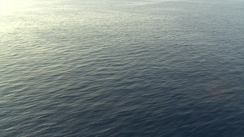 Flying low and fast over open sea. Aerial shot.