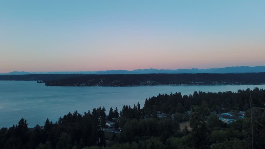 Aerial landscape of Lake Washington forest and mountains at sunset Bellevue suburb of Seattle WA USA