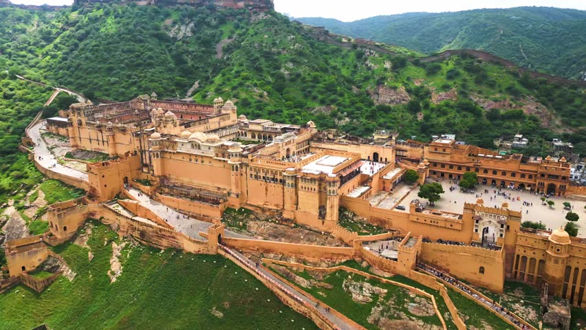 A grand Rajasthani fort stands tall, its intricate architecture and surrounding landscapes capturing timeless beauty
