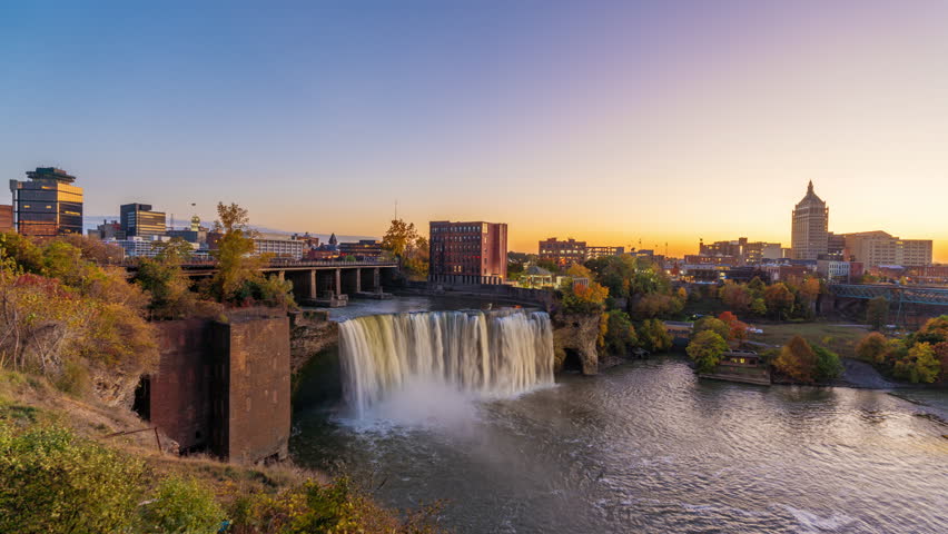 Rochester, New York, USA downtown skyline and waterfall from dusk till night.